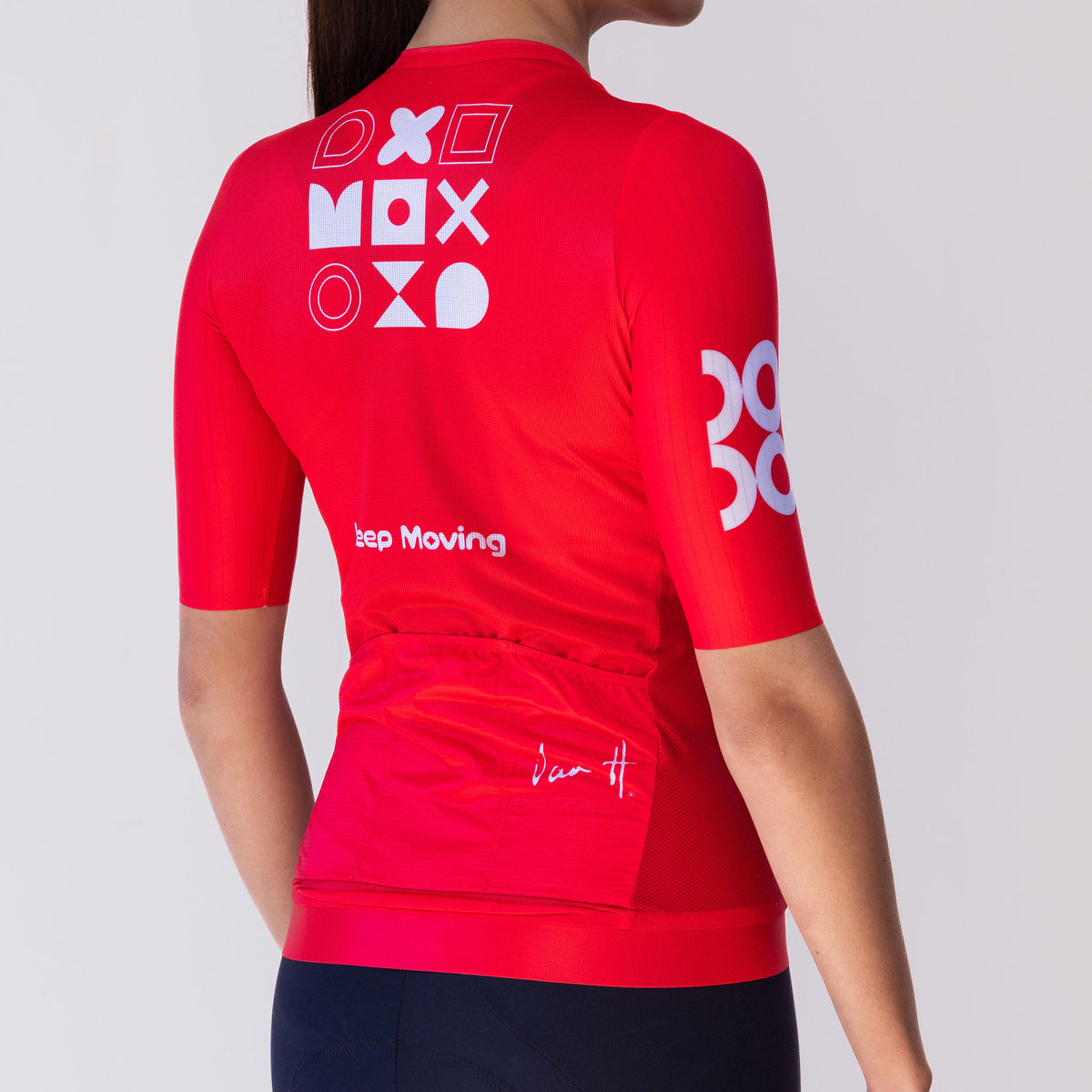 Women's Keep Moving cycling jersey in red, back view with geometric graphic and rear pockets